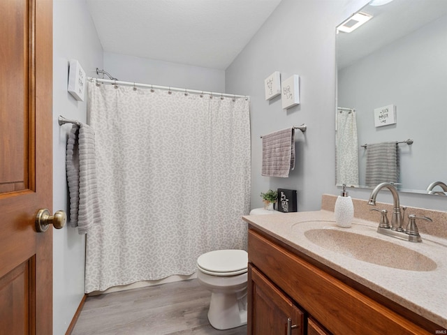 full bath featuring toilet, a shower with shower curtain, wood finished floors, visible vents, and vanity