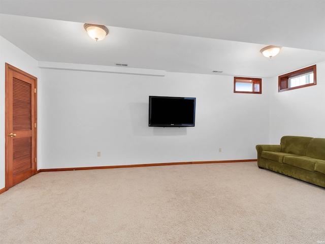 living room with carpet floors, visible vents, and baseboards