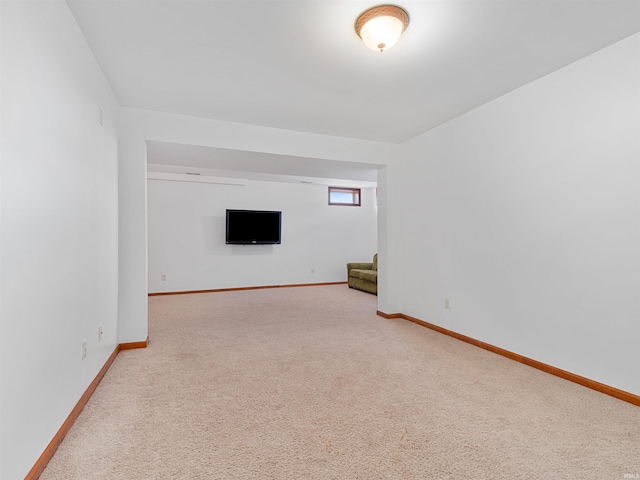 unfurnished living room with baseboards, stairway, and carpet flooring