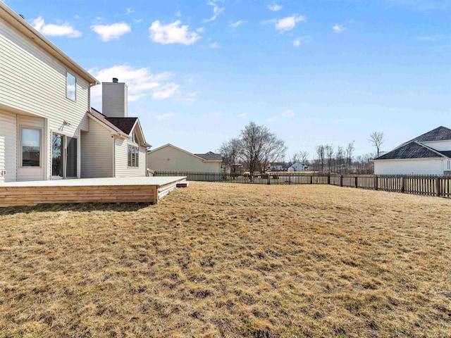 view of yard featuring a fenced backyard and a deck