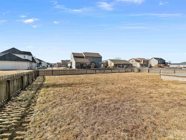 view of yard with a fenced backyard and a residential view