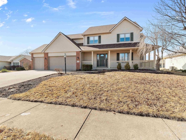 view of front facade featuring a porch, a garage, central AC, brick siding, and driveway