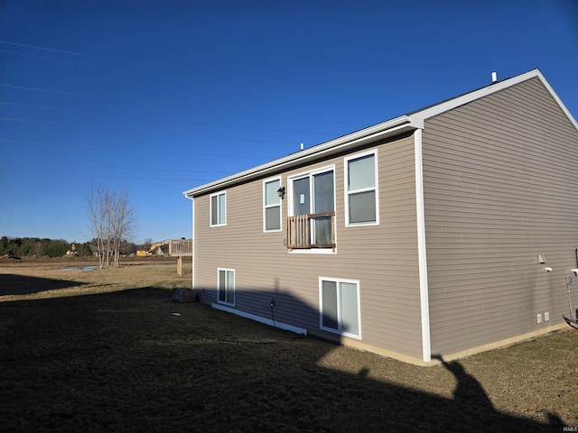 view of property exterior featuring a lawn