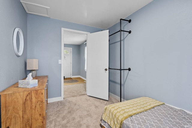 bedroom featuring carpet flooring, attic access, and baseboards