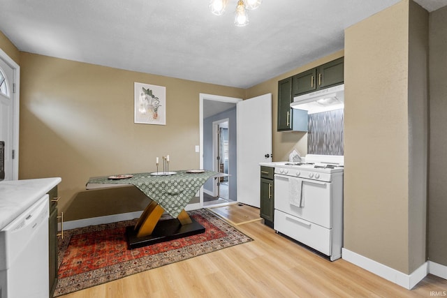 kitchen with light countertops, white appliances, light wood-type flooring, and under cabinet range hood