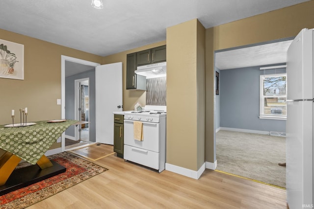 kitchen with visible vents, light wood-type flooring, white appliances, under cabinet range hood, and baseboards