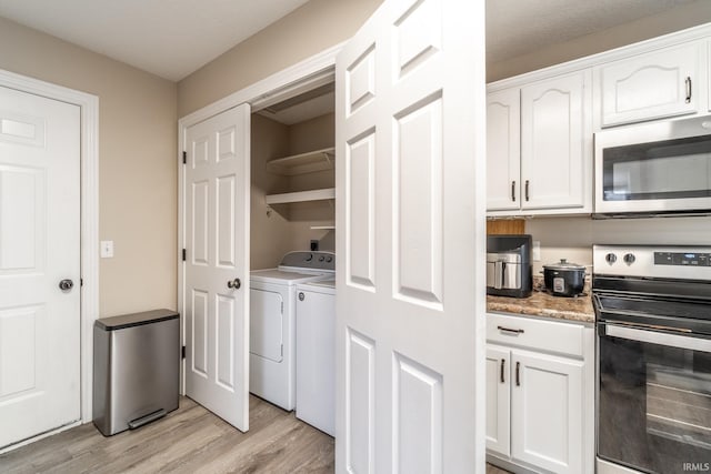 laundry room featuring laundry area, separate washer and dryer, and light wood-style flooring