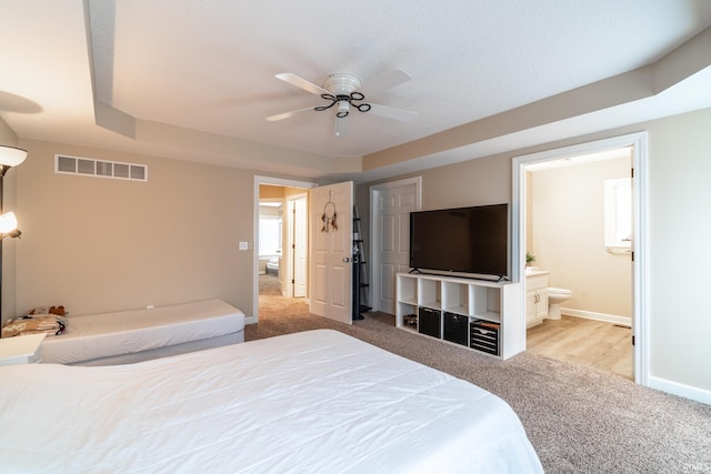 bedroom with baseboards, visible vents, a ceiling fan, ensuite bathroom, and carpet flooring