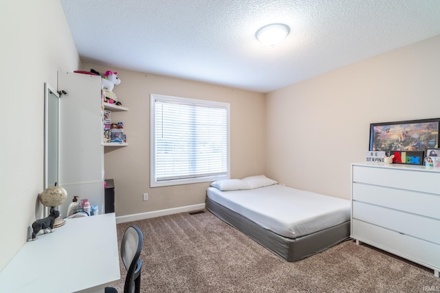 carpeted bedroom featuring a textured ceiling and baseboards