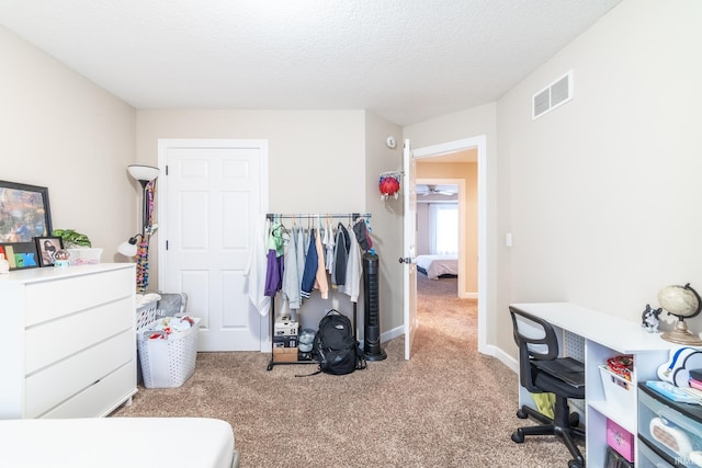 interior space with a textured ceiling, visible vents, and baseboards