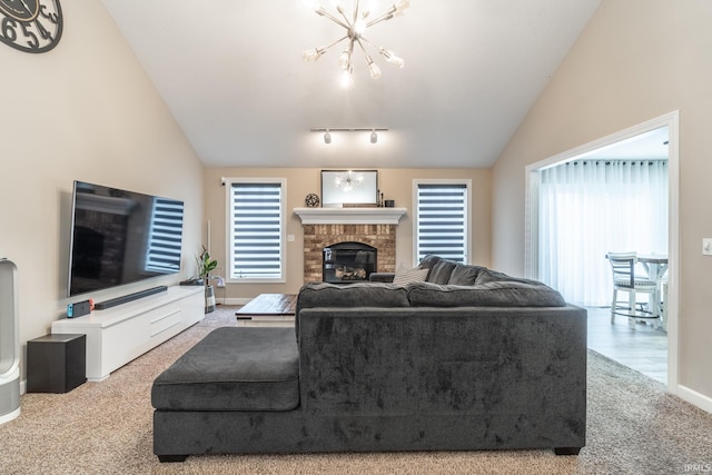 living room featuring lofted ceiling, a brick fireplace, carpet, and a chandelier