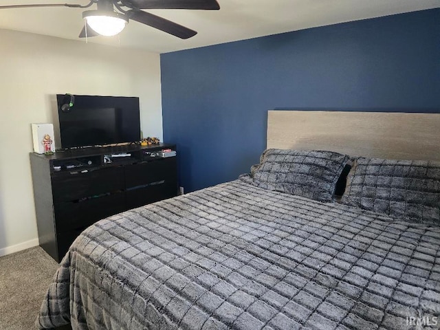 carpeted bedroom featuring a ceiling fan and baseboards