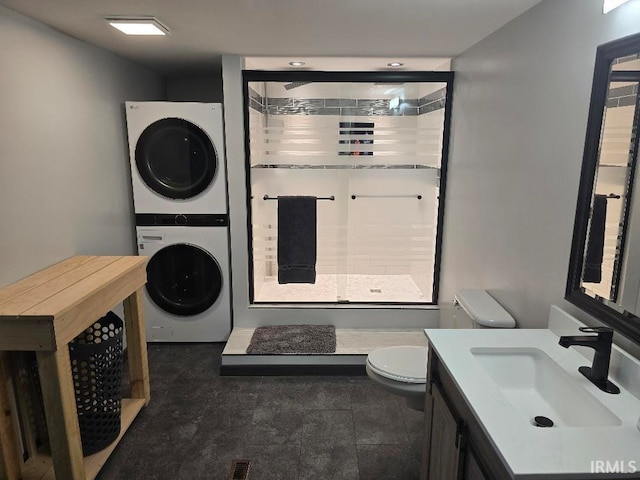 full bath with toilet, stacked washer and dryer, visible vents, vanity, and a shower stall