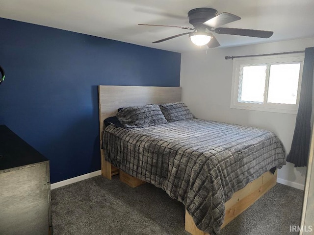 carpeted bedroom with ceiling fan and baseboards