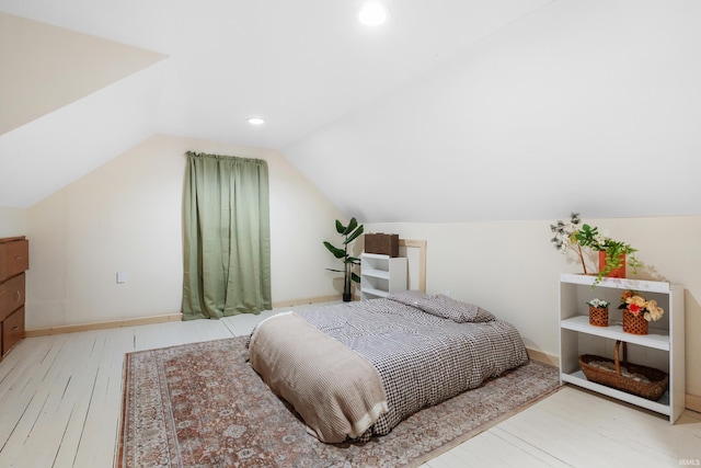 bedroom featuring vaulted ceiling, hardwood / wood-style floors, recessed lighting, and baseboards