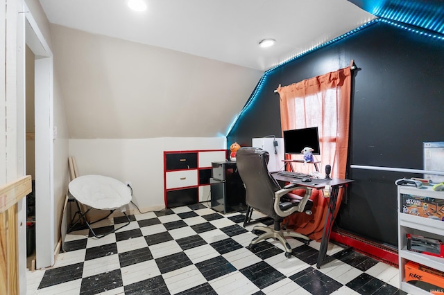 office with lofted ceiling and tile patterned floors