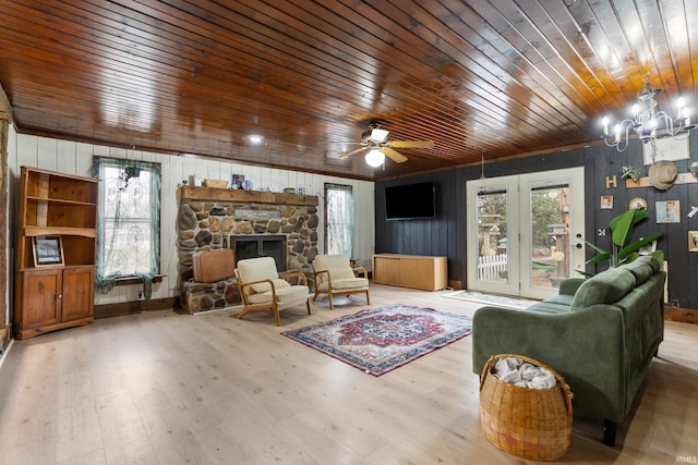 living area with wooden ceiling, a fireplace, wood finished floors, and ceiling fan with notable chandelier