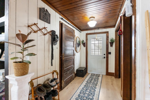 interior space featuring light wood-type flooring and wood ceiling