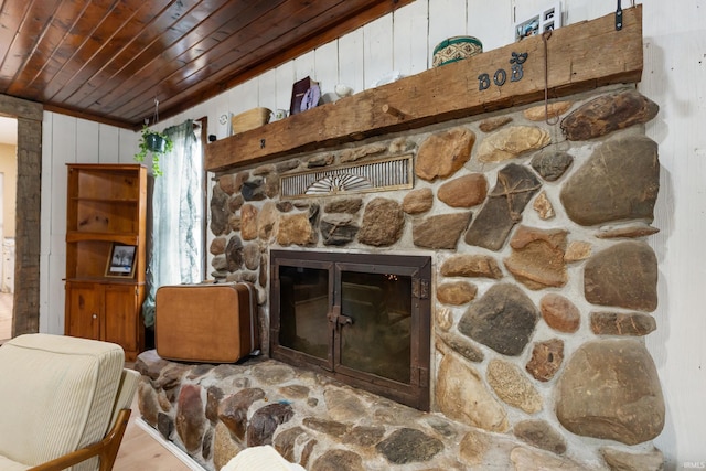 living room with wooden ceiling, a fireplace, wood finished floors, and wood walls