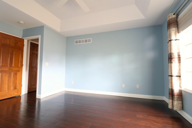 unfurnished bedroom featuring wood finished floors, visible vents, and baseboards