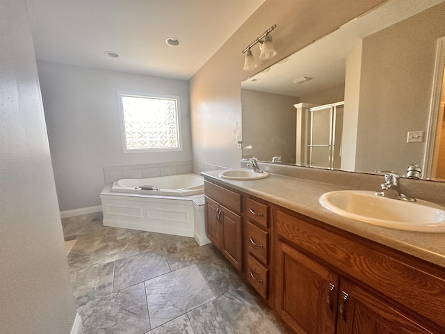 full bathroom with double vanity, a stall shower, a sink, and a bath