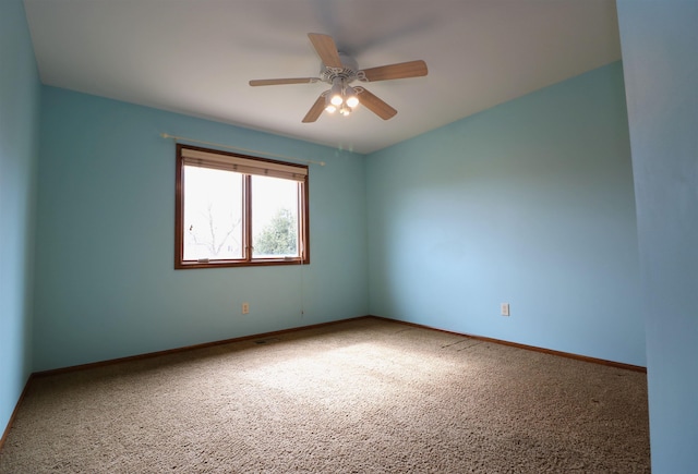 unfurnished room featuring carpet, ceiling fan, and baseboards