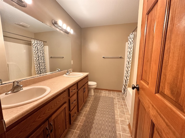 bathroom featuring toilet, double vanity, a sink, and a shower with shower curtain