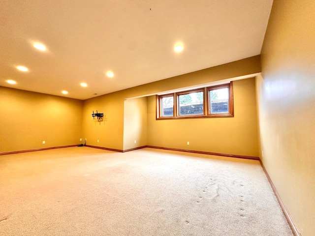 empty room with light carpet, baseboards, and recessed lighting