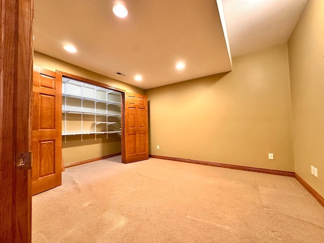 carpeted empty room with recessed lighting, visible vents, and baseboards