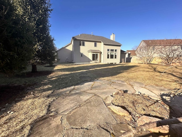 back of property with a chimney