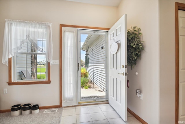 entrance foyer featuring light tile patterned floors, baseboards, and visible vents