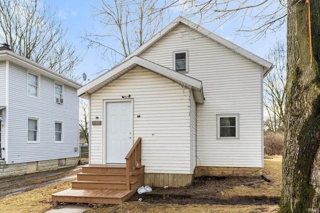 rear view of property with entry steps