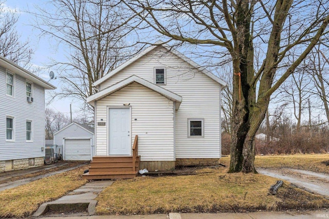 view of front of home featuring an outbuilding, driveway, and a detached garage