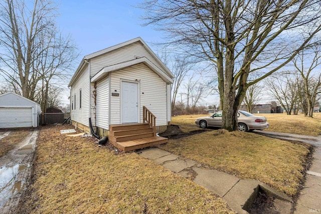 view of front of home featuring entry steps, an outbuilding, and a garage