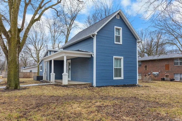 exterior space with a porch, fence, and a front lawn