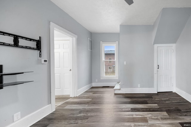 foyer with visible vents, baseboards, ceiling fan, wood finished floors, and a textured ceiling