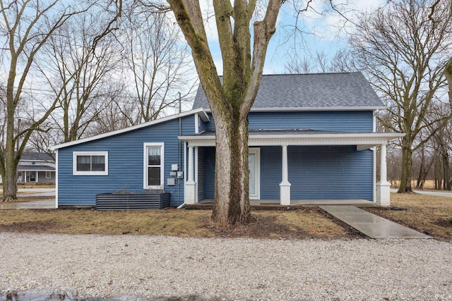 view of front of house with a shingled roof and a porch