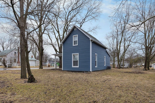 view of side of home featuring a yard