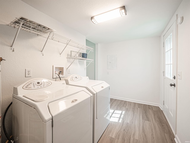 laundry room with light wood-type flooring, laundry area, baseboards, and separate washer and dryer