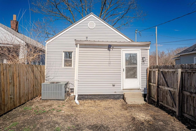 view of outbuilding featuring a fenced backyard and central air condition unit