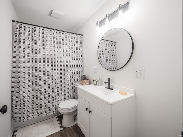 full bathroom with curtained shower, vanity, toilet, and wood finished floors