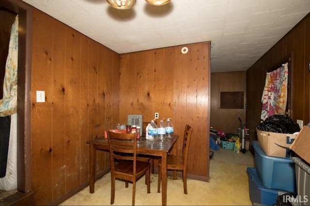 dining space featuring wooden walls