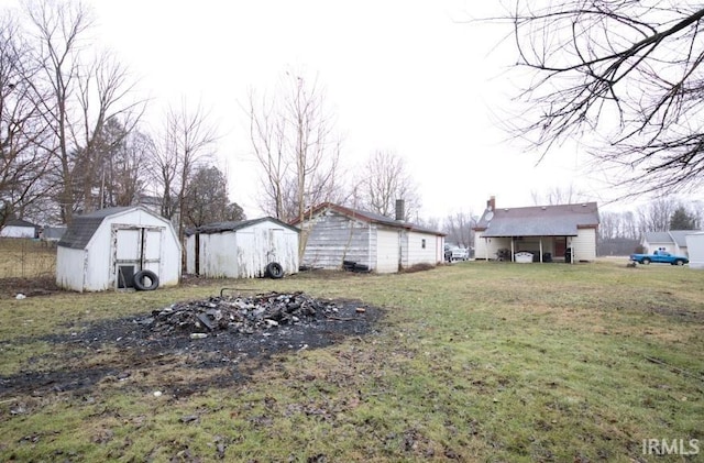 view of yard with a storage shed and an outbuilding