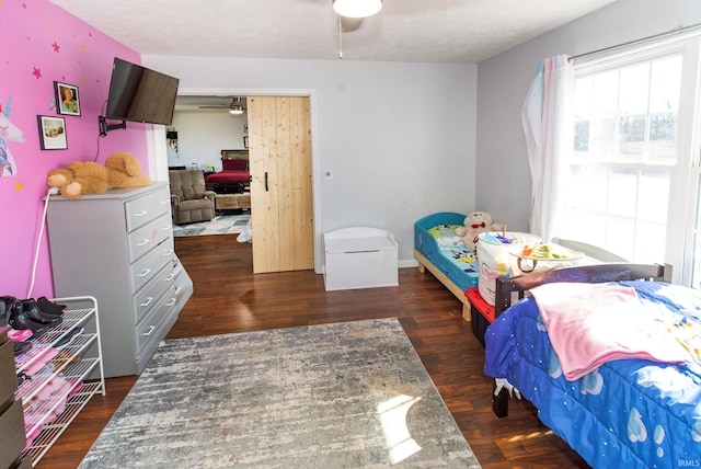 bedroom featuring a textured ceiling and wood finished floors