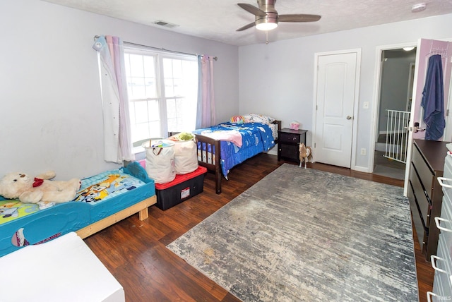 bedroom with visible vents, a ceiling fan, and wood finished floors