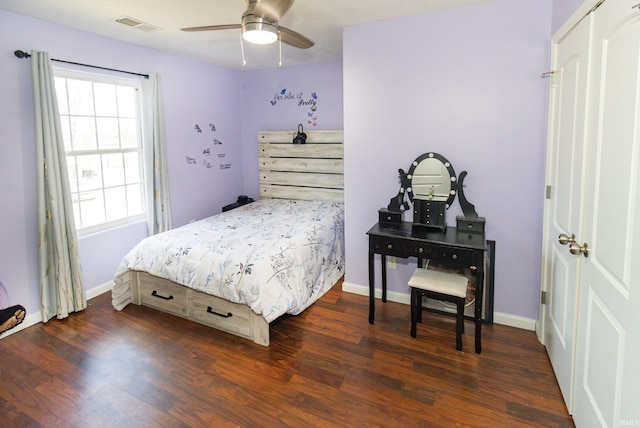 bedroom featuring baseboards, visible vents, and dark wood finished floors