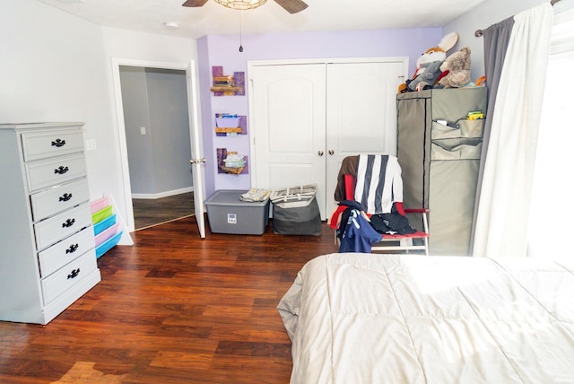 bedroom featuring a closet, a ceiling fan, wood finished floors, and freestanding refrigerator