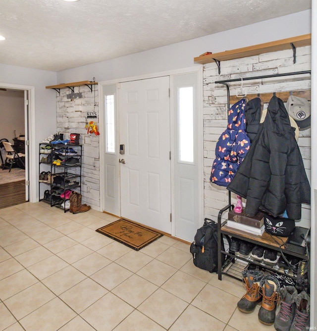 tiled foyer entrance with a textured ceiling