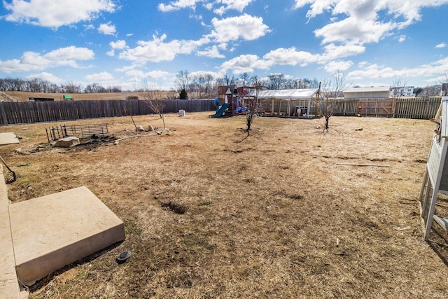 view of yard featuring a fenced backyard and a playground