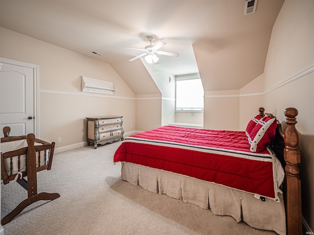 bedroom with vaulted ceiling, carpet flooring, visible vents, and baseboards